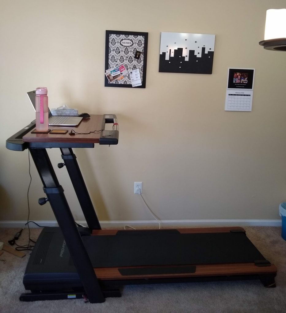 My treadmill desk is trimmed with faux-wood paneling which lets me pretend I'm working in the 70s. The work surface is wide enough to hold my computer, water bottle, and a box of Kleenex. All the essentials.