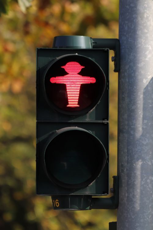 A red Do Not Walk stop light in East Berlin. Like all pedestrian traffic lights in the area, the light is shaped like an upright man, rather than being a plain red circle.