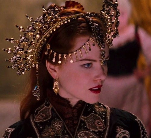 A movie still from Moulin Rouge. It shows the lead character, Satine, in fancy gold headdress.