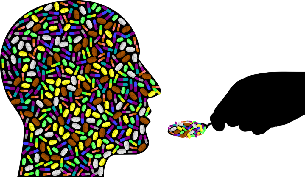 This graphic shows the outline of a man's head, facing to the right. The outline is filled in with pain pills. On the right, there's an outline of a person's hand holding a spoon full of more pain pills.