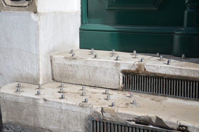 This photo from Marseilles, France, shows two wide concrete ledges with nubby metal spikes sticking out of them. These spikes cannot possibly serve any purpose, except to deter people from sitting or lying down.