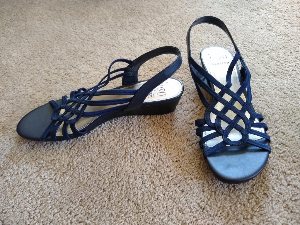 A photo of the strappy, navy-blue sandals I wear for special occasions. The heel can't be more than an inch high.